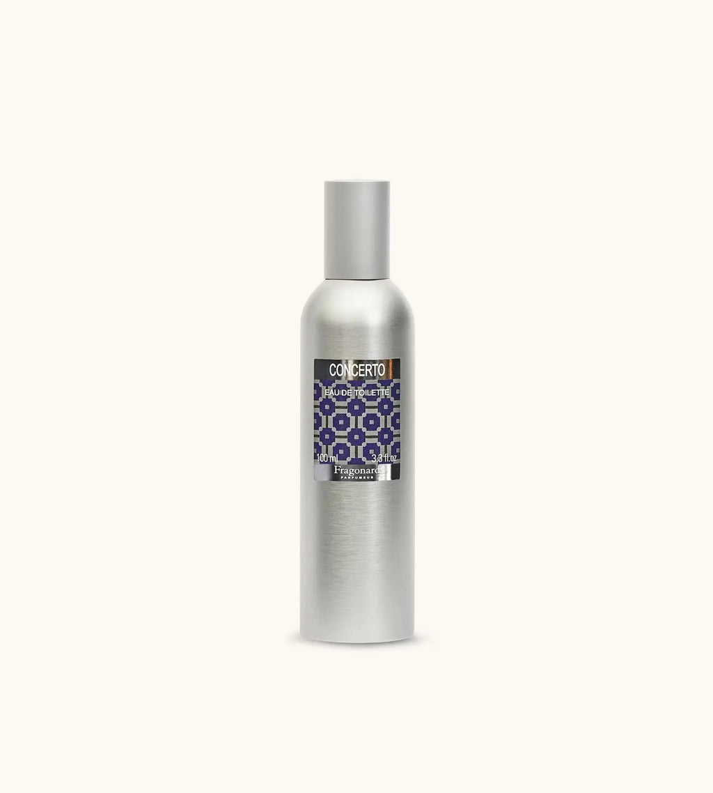 Flacone Di Profumo Fragonard Concerto Eau De Toilette 100 Ml Su Sfondo Con Dettagli Agrumati E Speziati.
