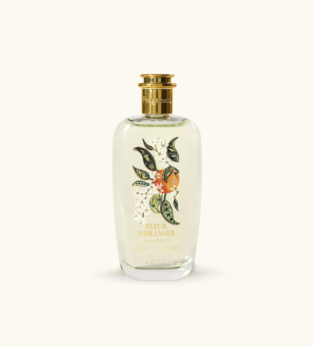 Flacone Di Profumo Fragonard Fleur D Oranger Eau De Toilette 100 Ml Su Sfondo Con Fiori D Arancio E Agrumi.